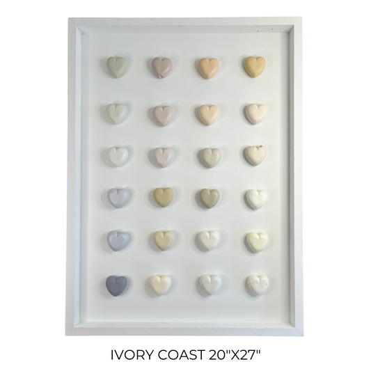 Framed display of heart-shaped objects in various colors on a white background