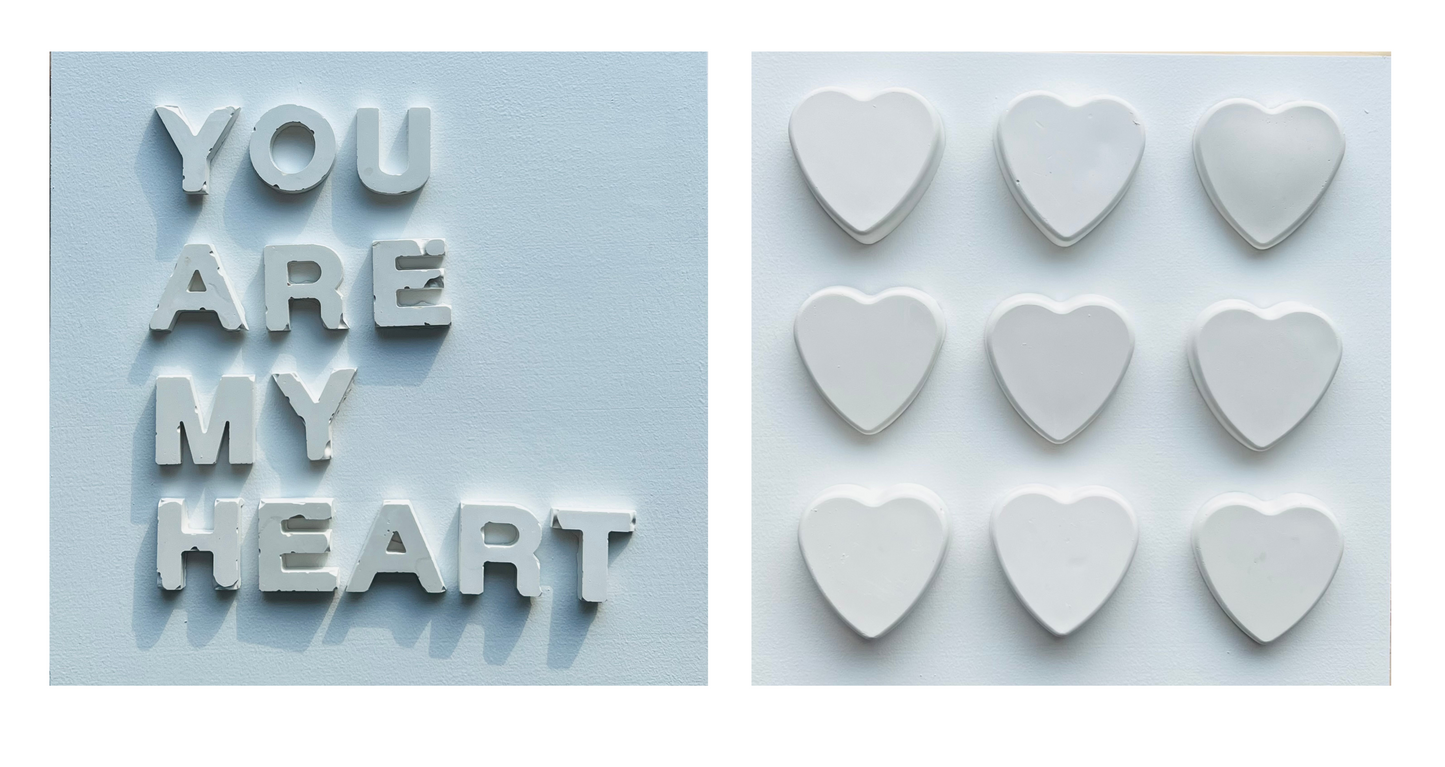Text 'YOU ARE MY HEART' with heart-shaped objects on a light blue background