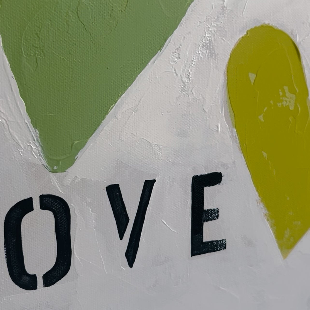 Text 'LOVE' with green and yellow heart shapes on a textured white background
