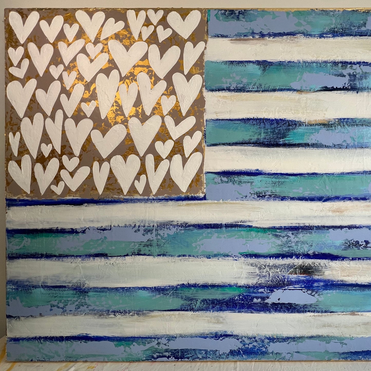 Artistic wall piece with heart pattern on the left and horizontal striped design on the right.