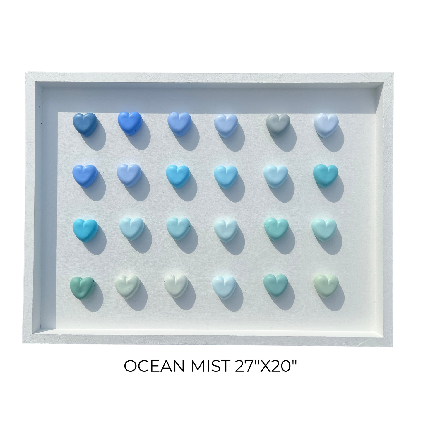 Decorative wall art with heart-shaped objects in ocean mist colors on a white background