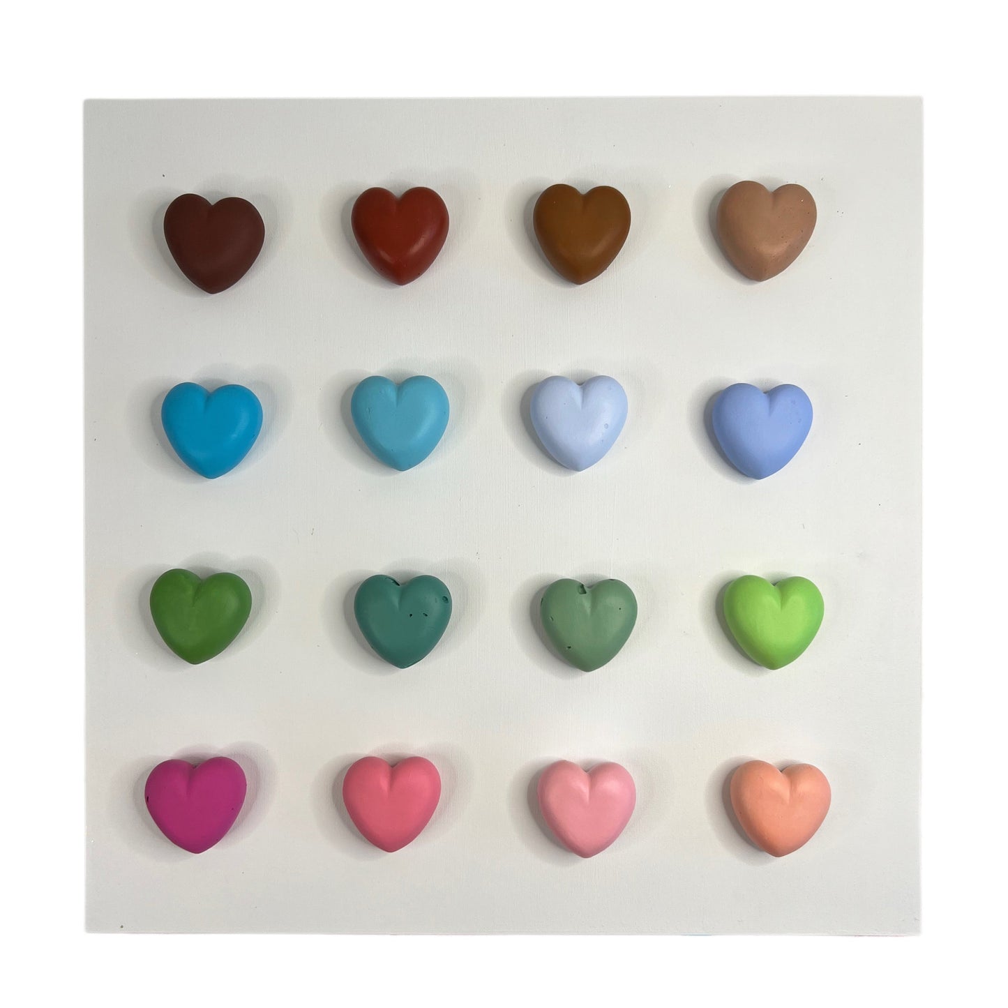 Set of colorful heart-shaped candies on a white background