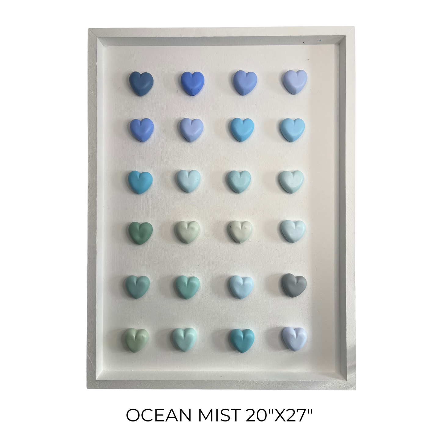 Framed artwork with heart-shaped objects in ocean mist colors on a white background