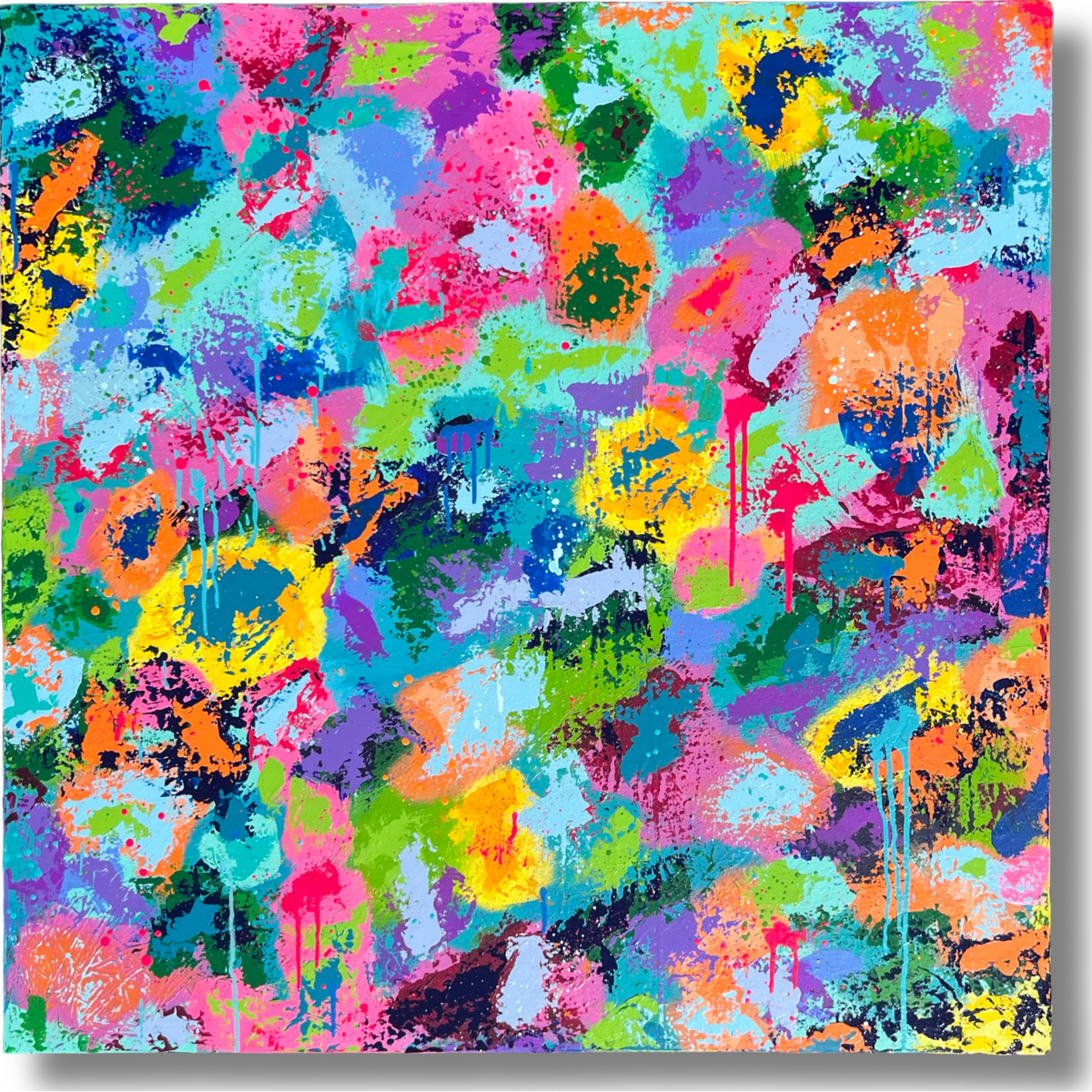 A square abstract canvas print featuring a vibrant, multicolored graffiti-style paint splatter pattern with drips and splashes of pink, blue, green, yellow, orange, and purple.