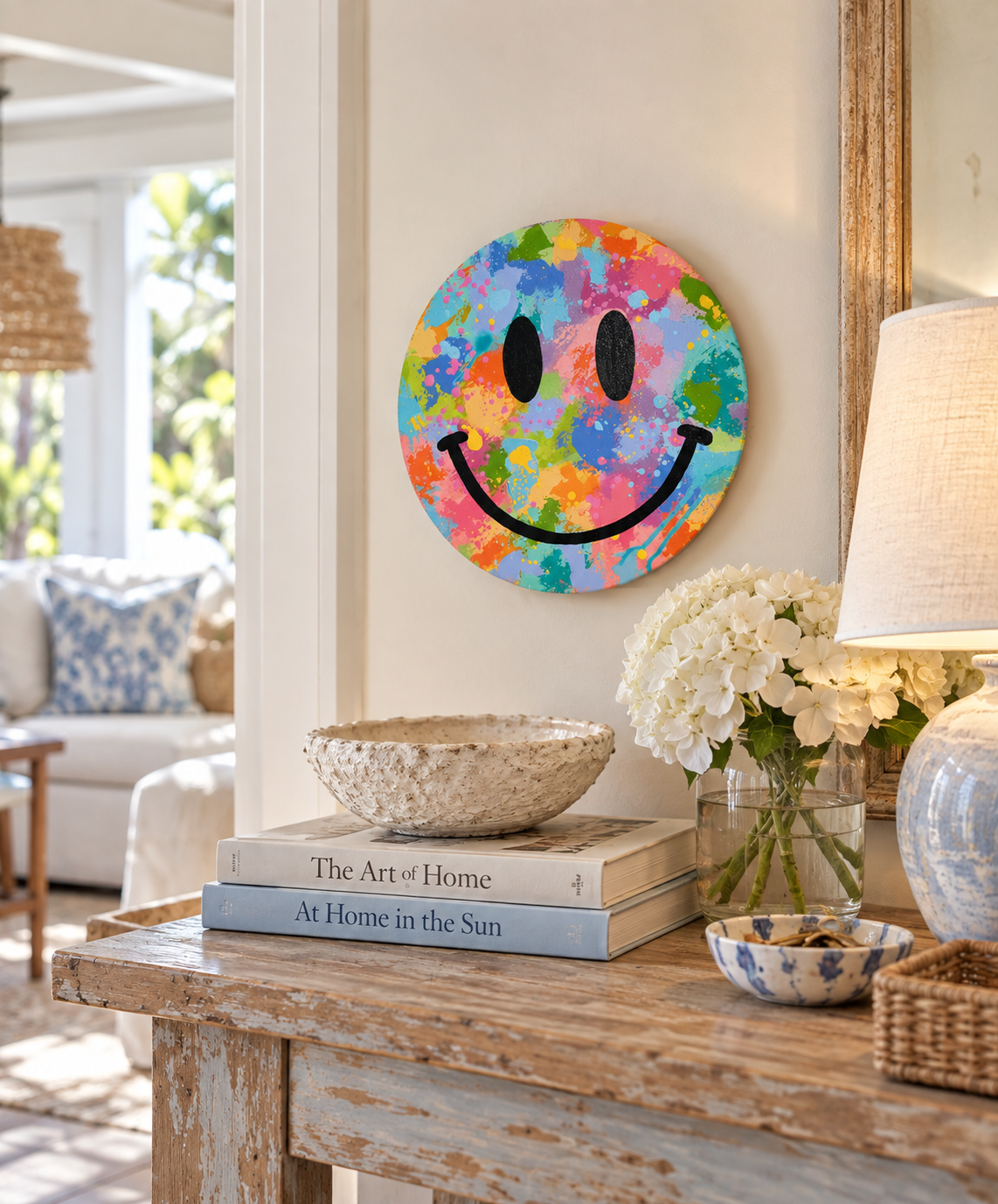 Colorful 12-inch round smiley face original painting displayed in a bright, relaxed coastal-style home above a natural wood console.