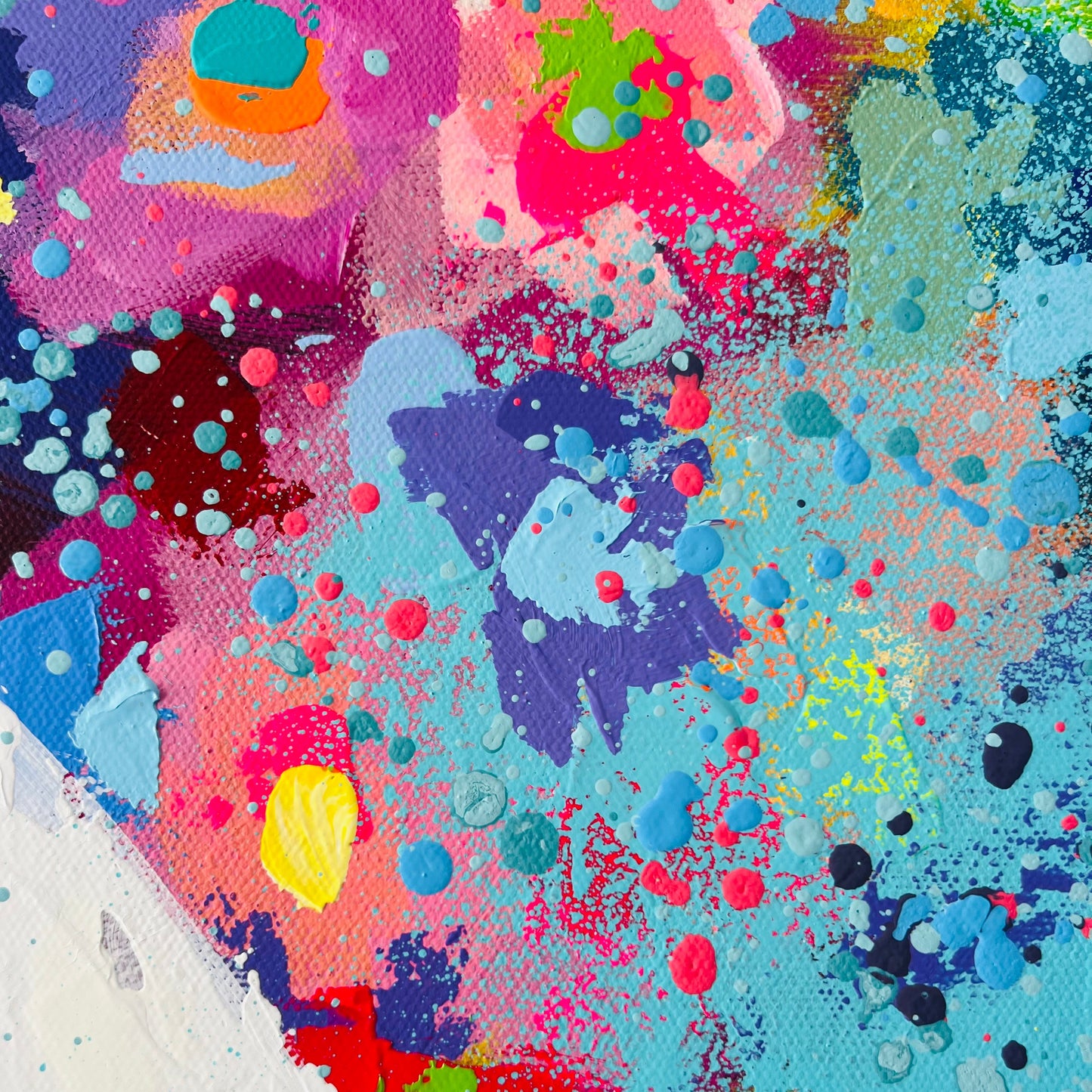 Abstract artwork with vibrant colors and splashes on a textured surface
