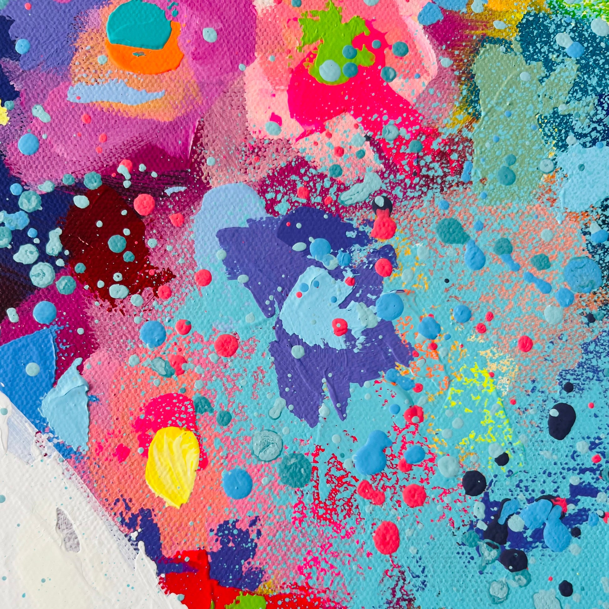 Abstract artwork with vibrant colors and splashes on a textured surface