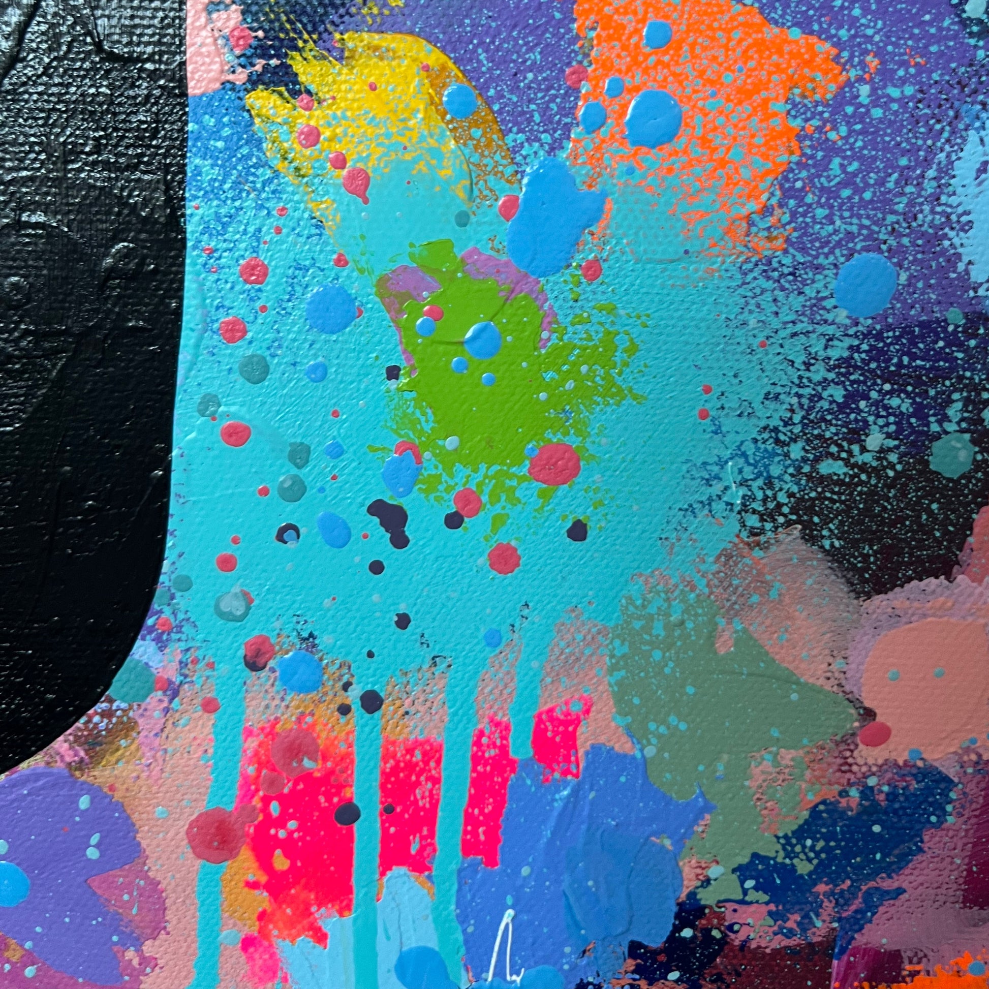Colorful abstract art with splashes of paint on a textured surface