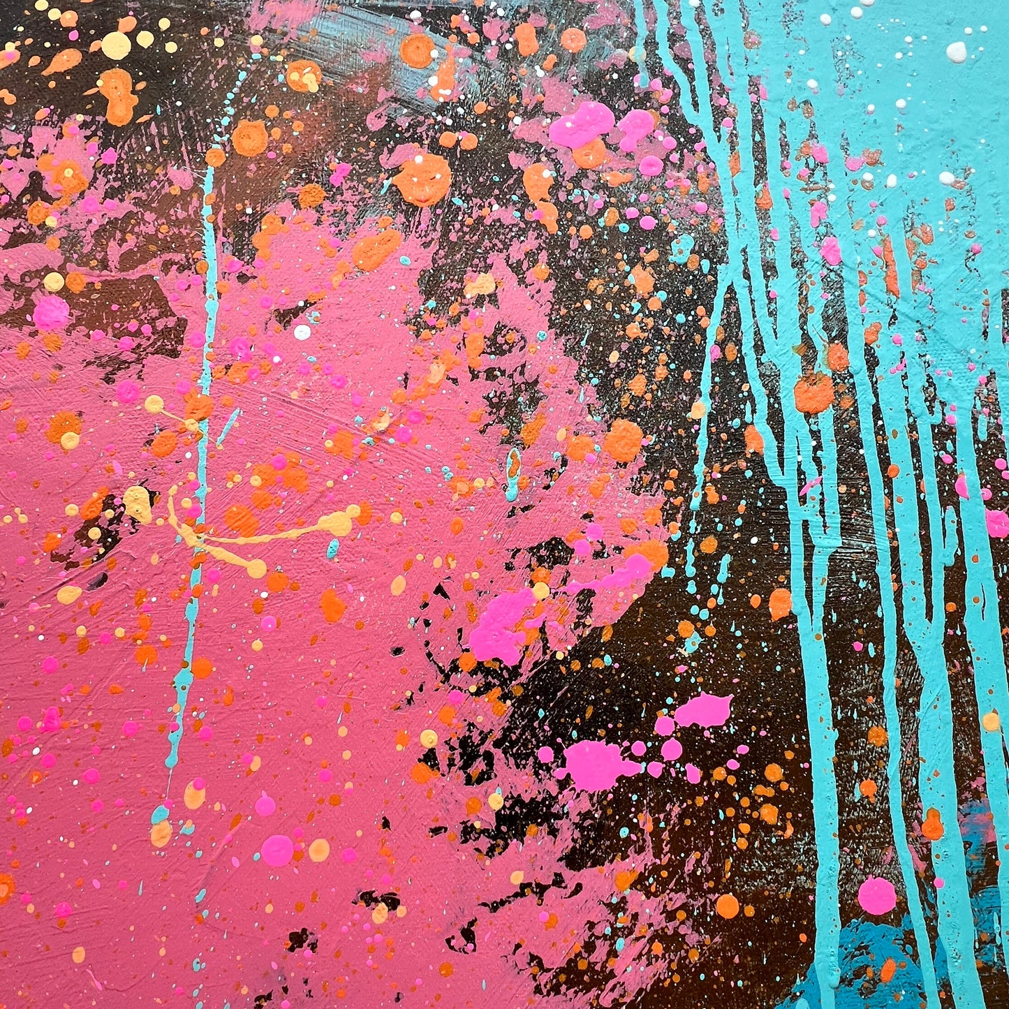 Abstract artwork with splashes of pink, orange, and blue on a dark background
