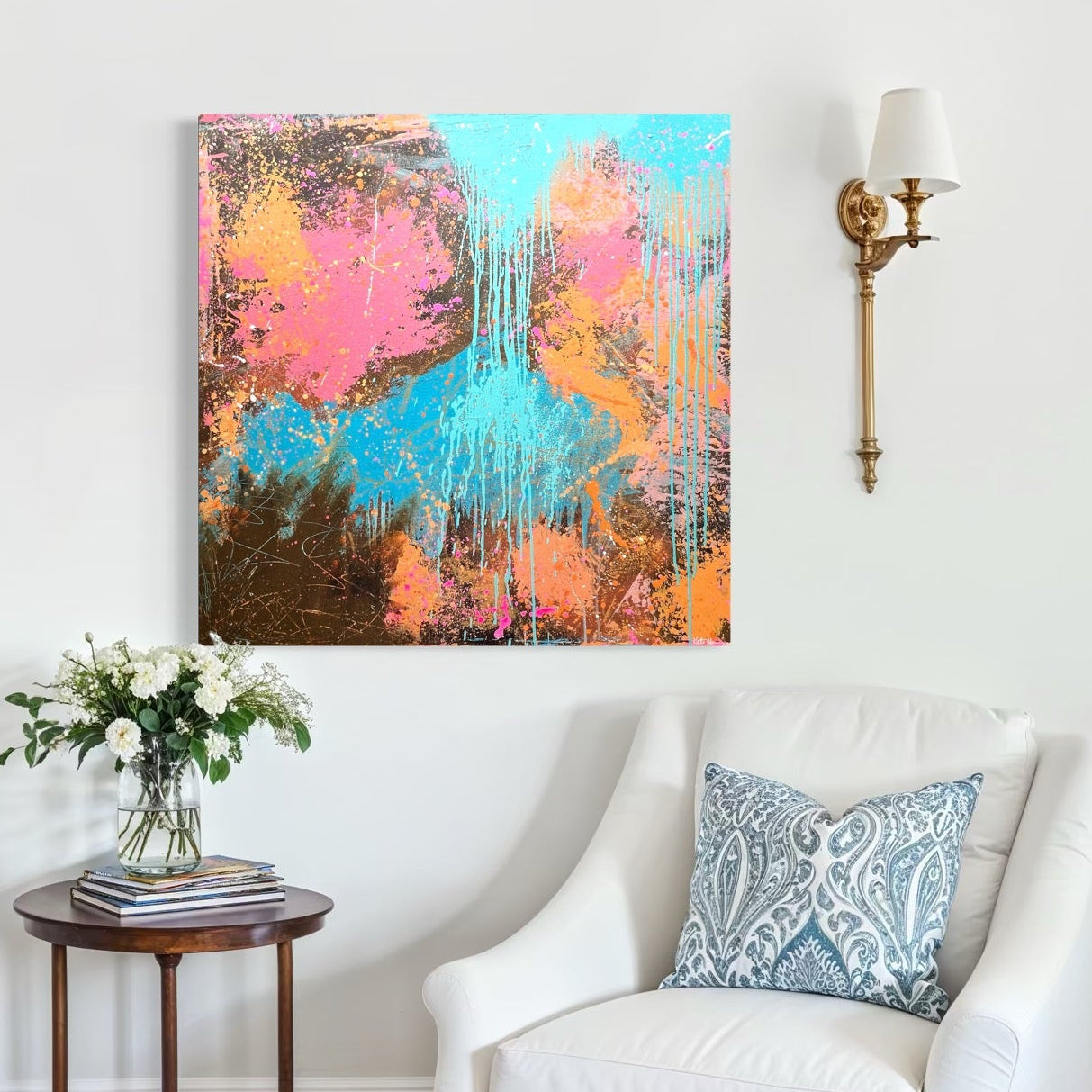 Living room with white armchairs, a small table, and a colorful abstract painting on the wall.