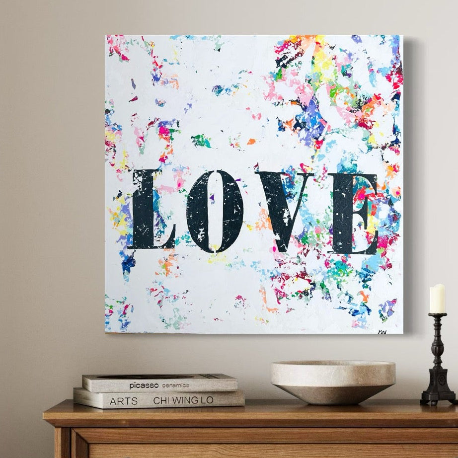 Wooden dresser with decorative items and a colorful 'LOVE' painting in a room with open doors.