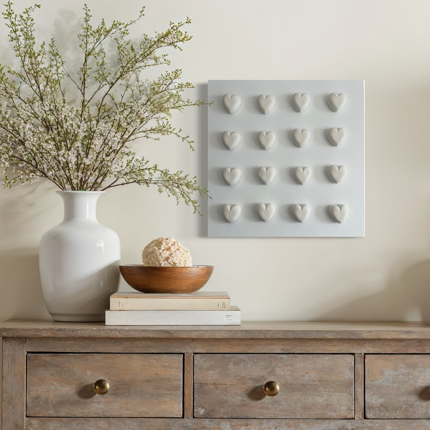 Console table with decorative items including a vase, lamp, and framed art on a neutral wall.