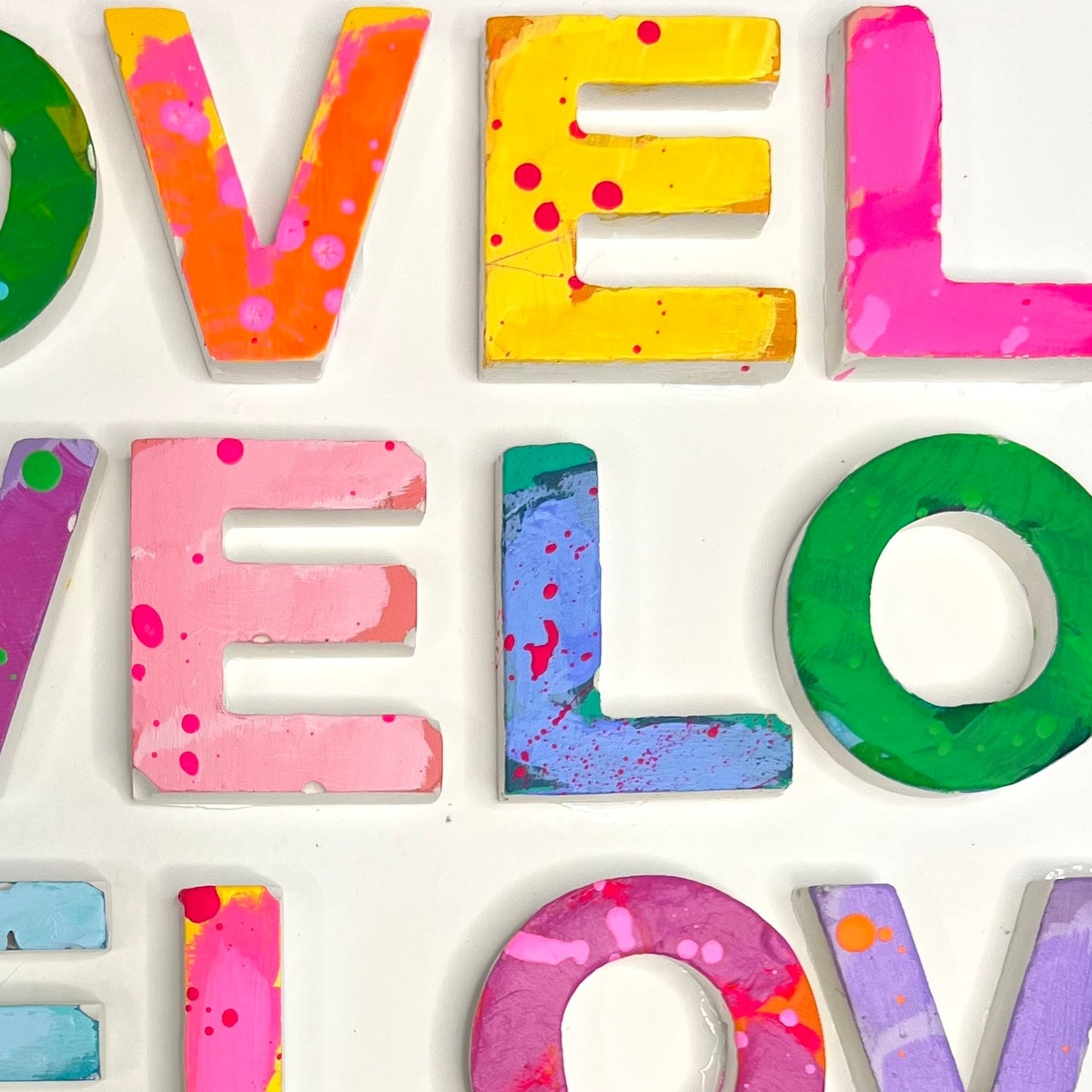 Colorful letter blocks spelling 'LOVE' on a white background