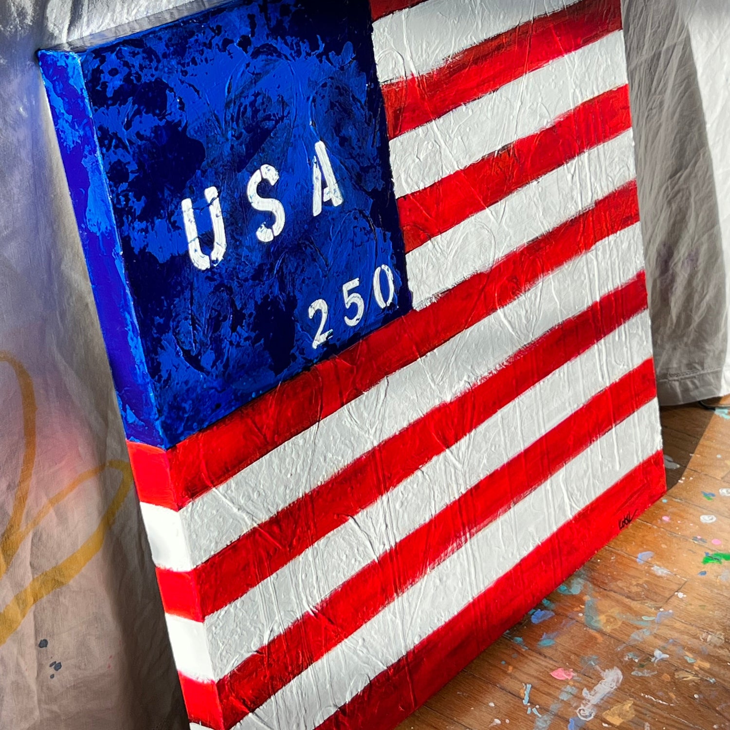 American flag with 'USA 250' text on a wooden surface