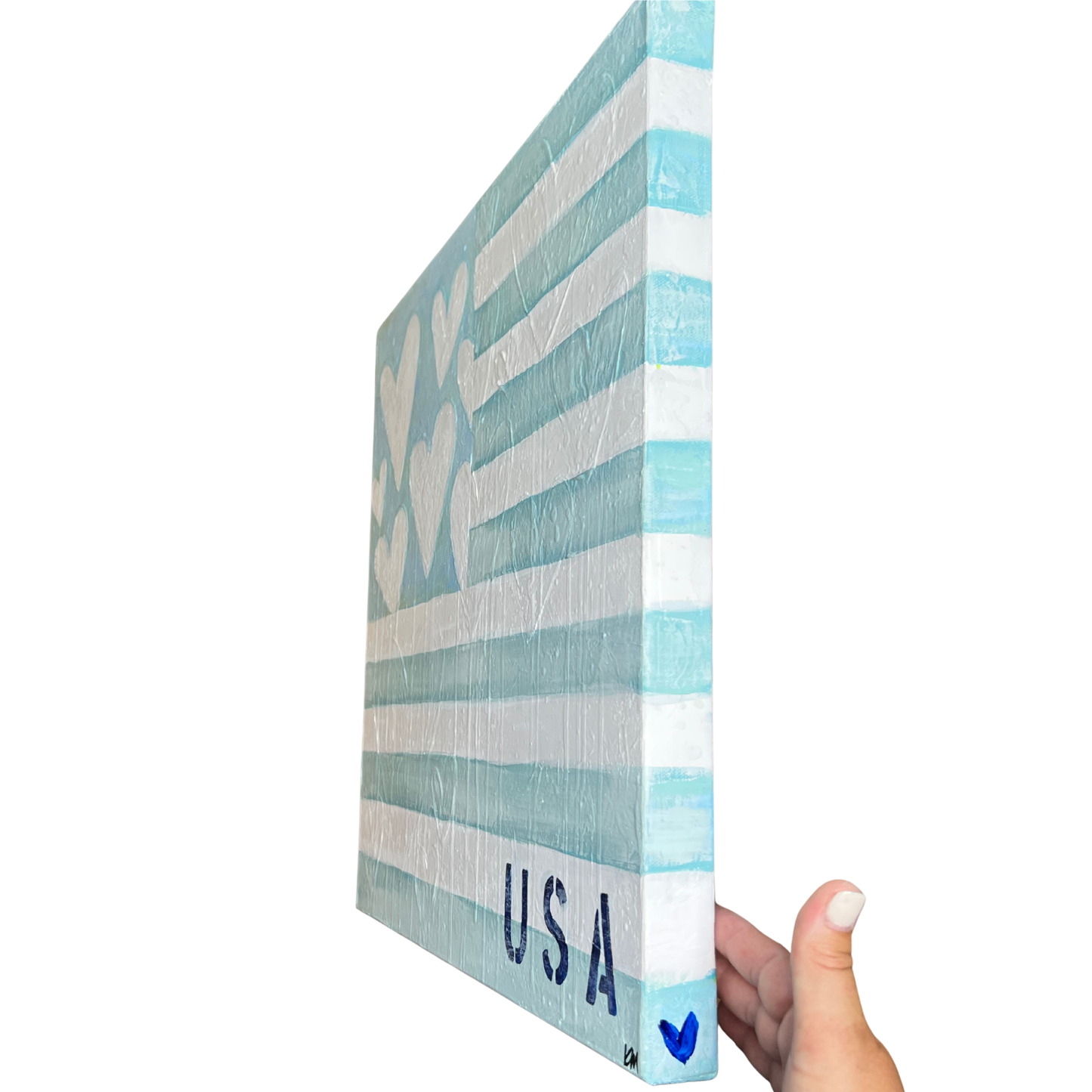 Hand holding a decorative box with 'USA' and heart design on a white background