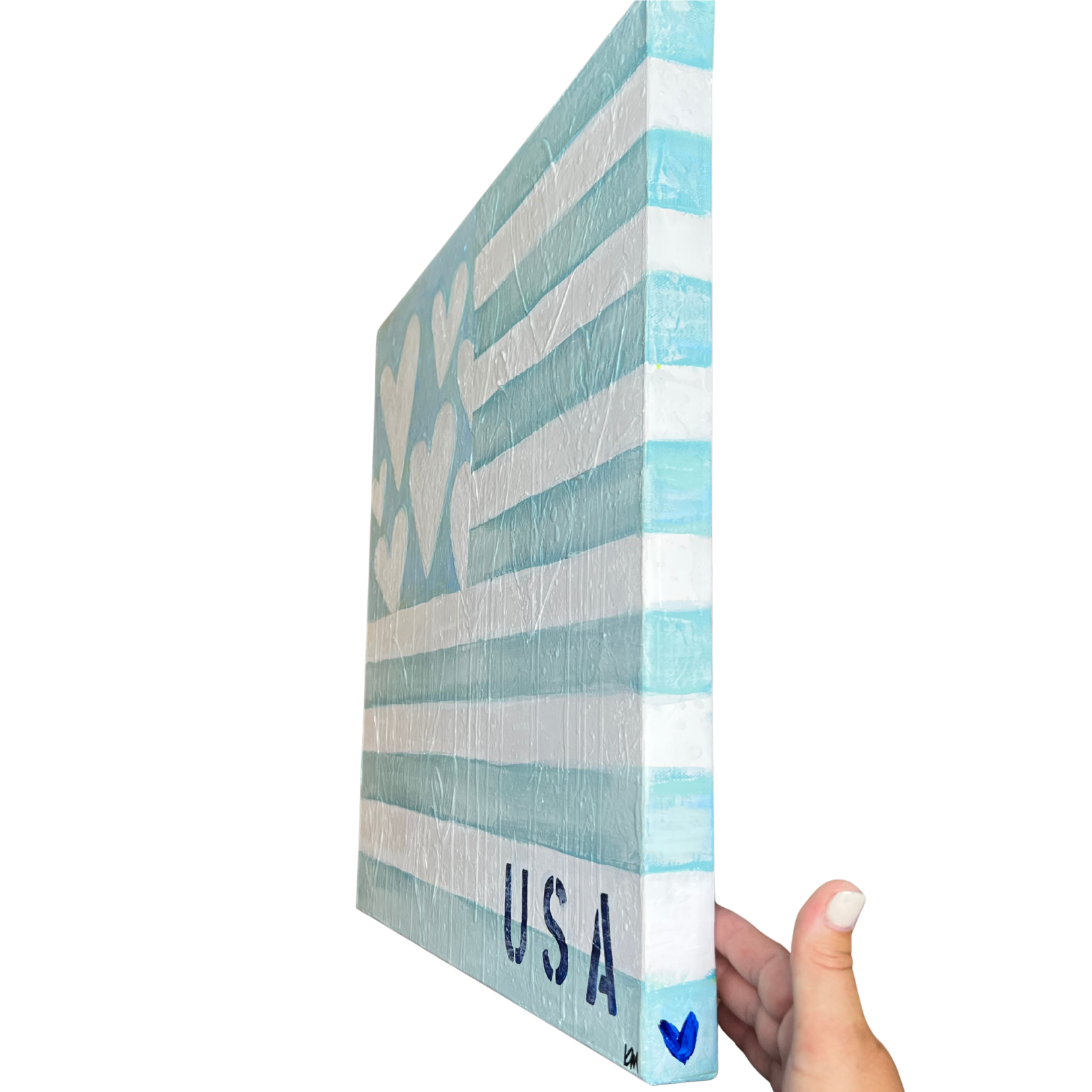 Hand holding a decorative box with 'USA' and heart design on a white background