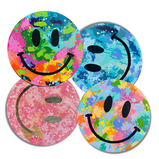 Four original 12-inch round smiley face paintings from the Happy Looks Good On You collection, featuring layered colorful acrylic paint, playful marks and splatters.