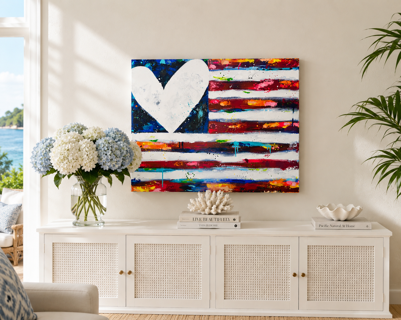 Colorful abstract painting with a heart design on a wall above a white cabinet in a living room.