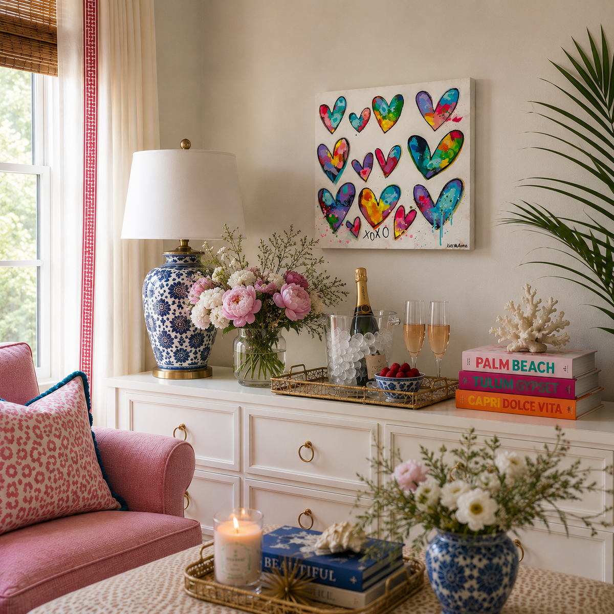 Living room with a pink sofa, decorative lamp, and colorful heart painting.